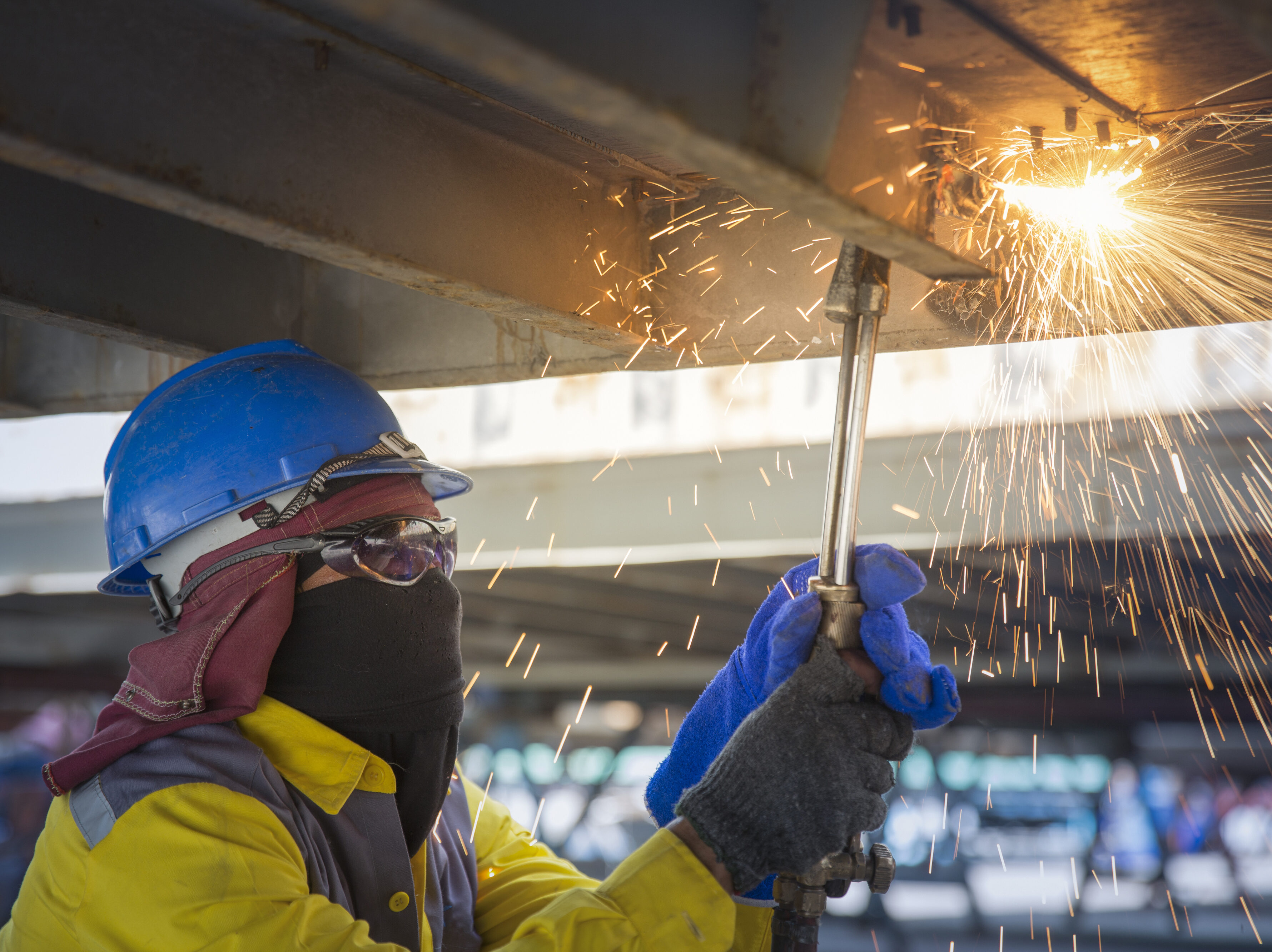 Worker cut the steel base for repair container